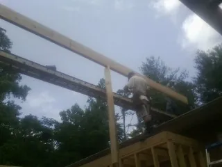 Carpenter setting a ridge beam over a new addition frame — Ice Dam Removal by Roofing Brothers in Desert Hot Springs