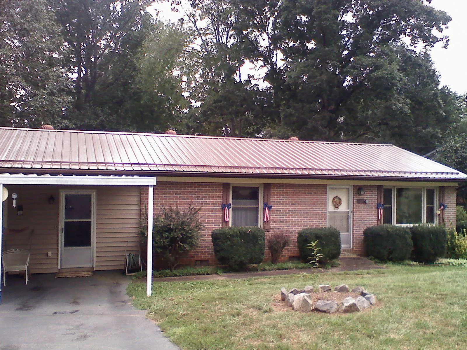 Bronze metal roof and carport on a brick ranch home — Roof Repair work by our crew in Desert Hot Springs