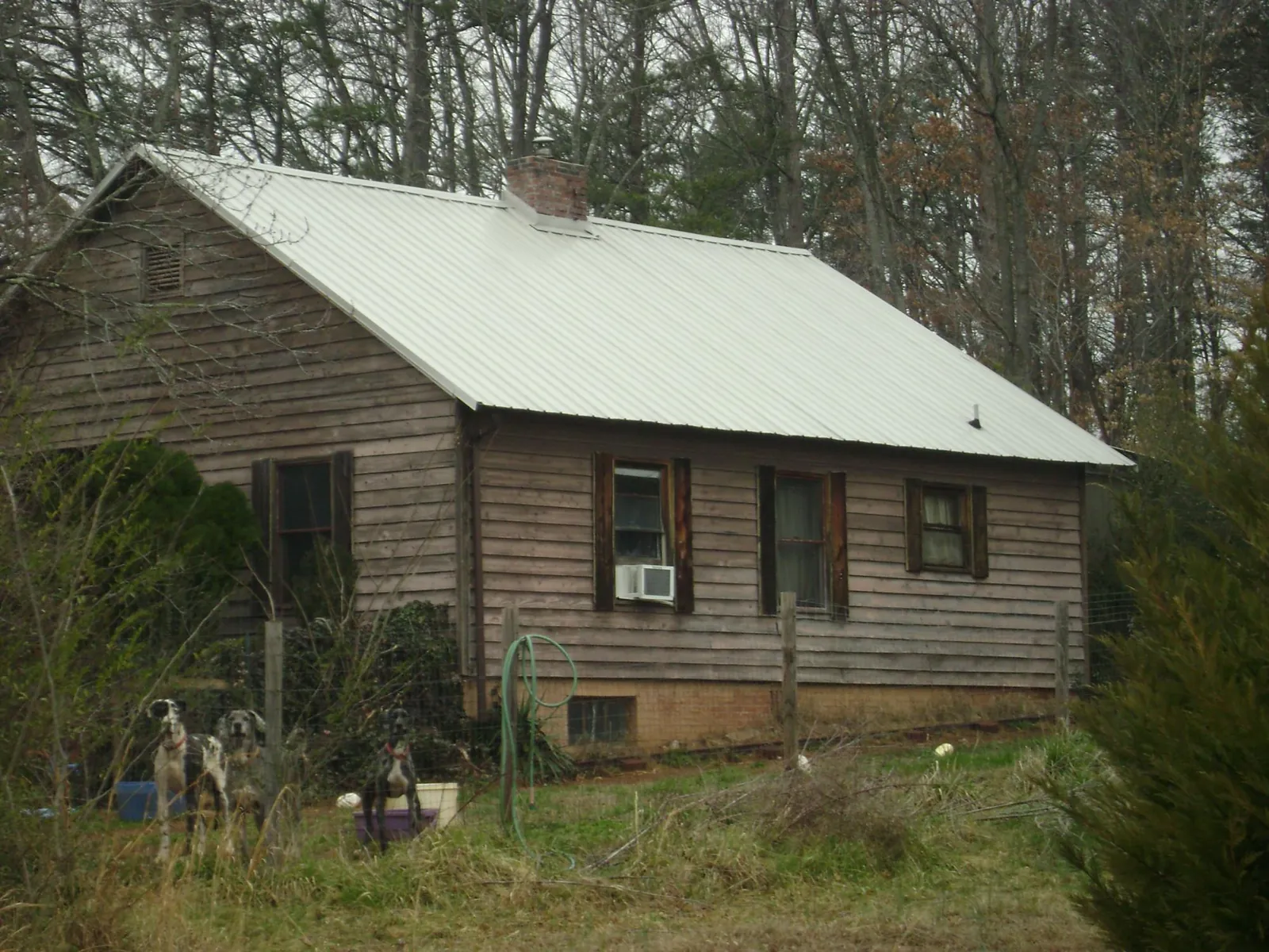 White metal roof on an old wood sided farmhouse, from a Asphalt Shingle Roof Repair job in Desert Hot Springs